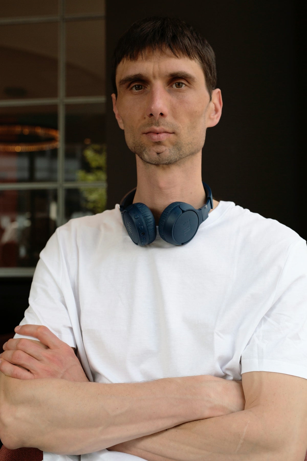 Man wearing headphones around his neck