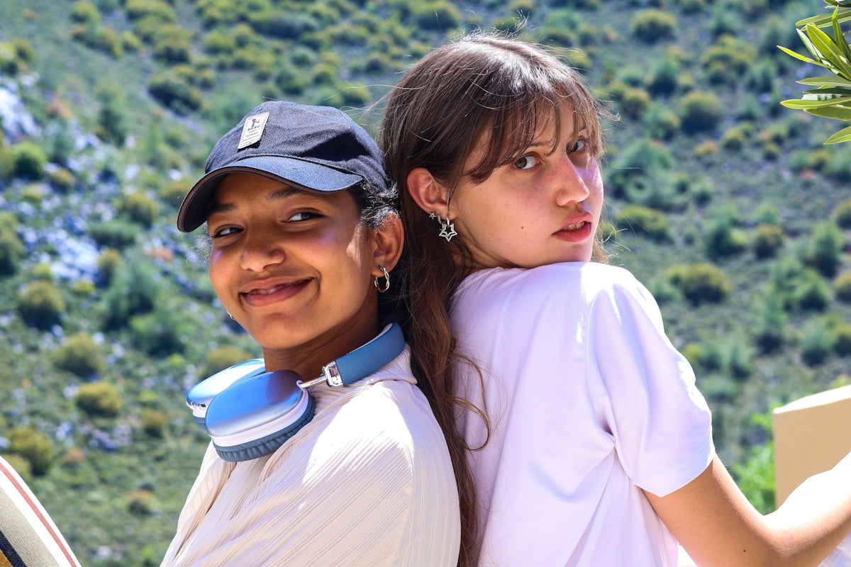 Two young people with headphones outdoors